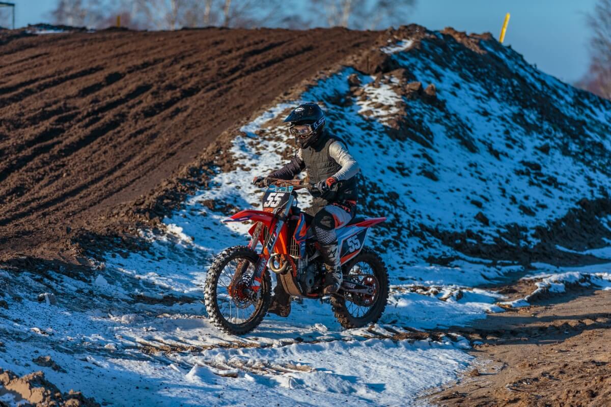 Dirtbike rider in winter on motocross track